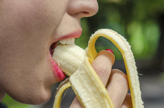 Beautiful Girl Eating Banana Closeup