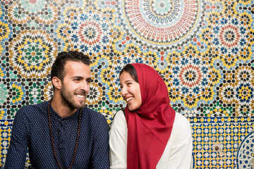 Young Muslim couple in relationship in front of arabesque oriental decoration