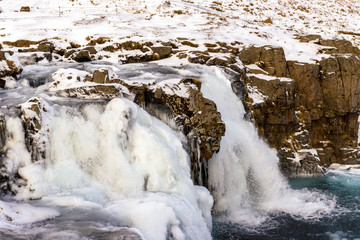 Water falling at Mount Kirkjufell at winter in Iceland. Water falls.