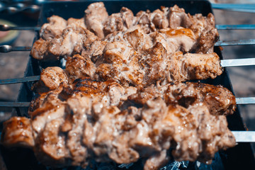 Grilled kebab cooking on metal skewers (grill).
