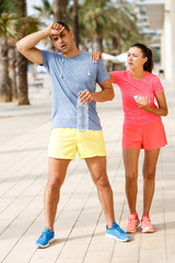 Tired couple resting after workout