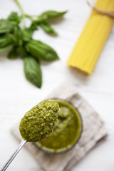 Spoon of basil pesto, top view. Overhead.