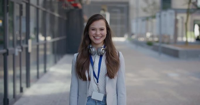 portrait young lively business woman student smiling excited enjoying professional urban lifestyle success in city slow motion corporate intern