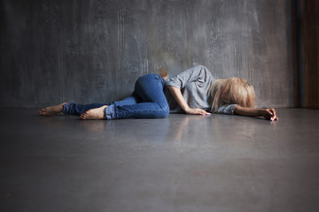 Mental health. Young woman lying on the floor
