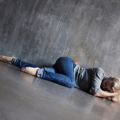 Mental problems. Young woman lying on the floor