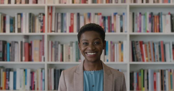 portrait successful black business woman smiling enjoying professional career accomplishment stylish african american female  in library study background