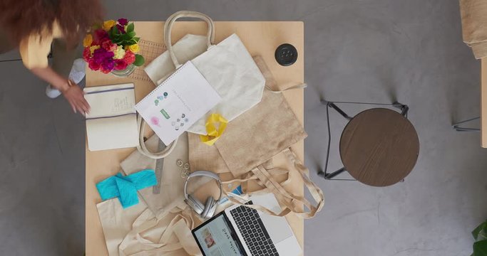 time lapse young entrepreneur women in successful startup business working designing fashion handbags drawing sketching using tablet technology in vibrant workspace studio top view track
