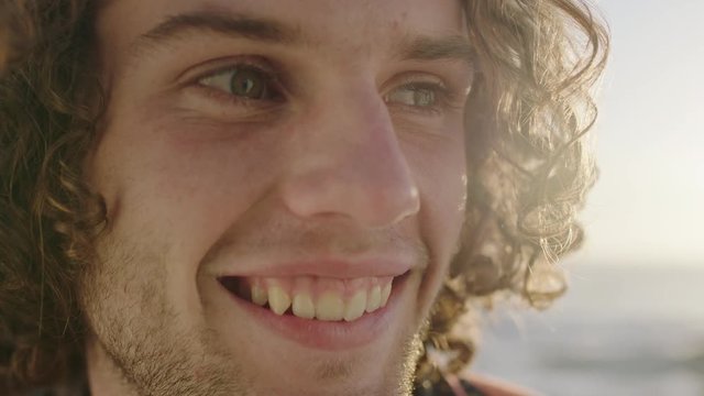 attractive young man portrait of cute guy smiling relaxed looking at camera enjoying happy lifestyle
