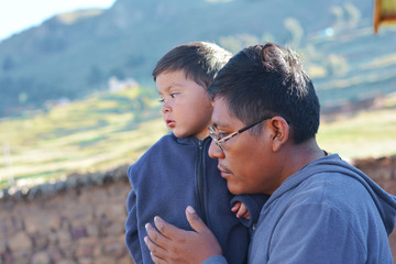 Native american man with his little son in the countryside.