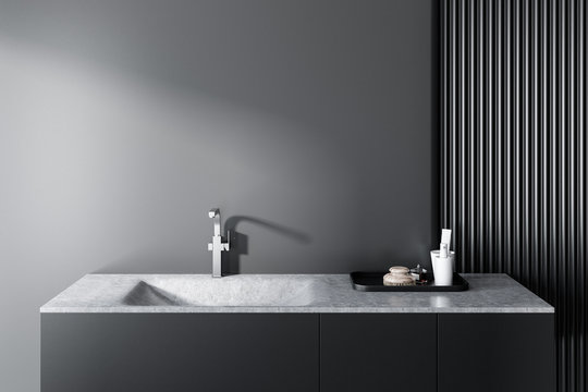 Gray bathroom sink, gray wall