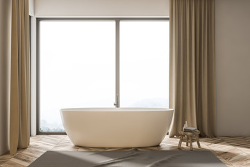 Fototapeta na wymiar White bathtub in a beige curtains bathroom