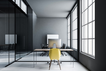Dark gray office workplace, yellow chair