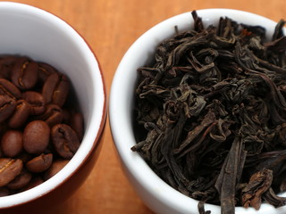 Raw coffee and tea. Dry coffee and tea in a cup.