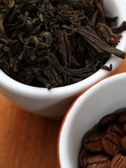 Raw coffee and tea. Dry coffee and tea in a cup.