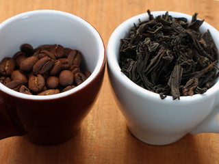 Raw coffee and tea. Dry coffee and tea in a cup.