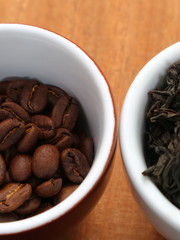 Raw coffee and tea. Dry coffee and tea in a cup.