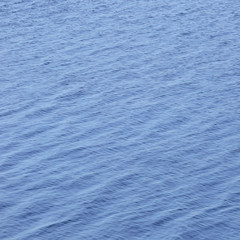 Vertical ocean water waves background pattern, abstract blue gentle bokeh bright ripples texture, scenic vibrant seascape summer season surface, large detailed copy space wallpaper