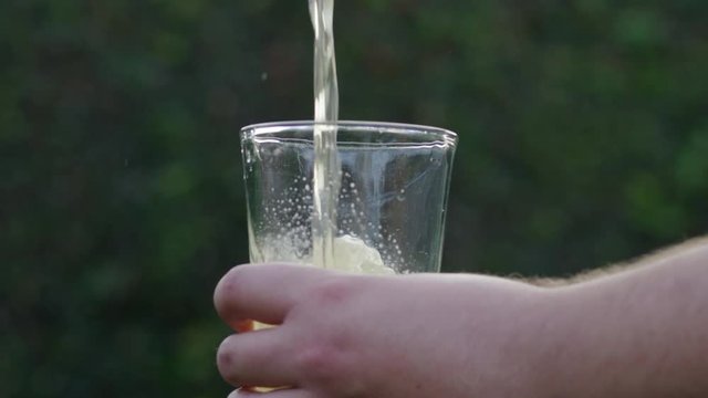 SLOW MOTION pouring beer into glass
