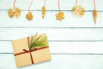 Christmas gift in a box and decorations. On a white wooden background.