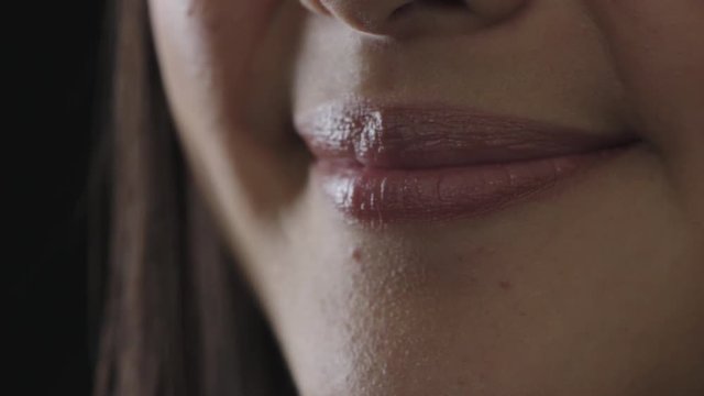 close up woman mouth smiling cheerful glossy lips healthy teeth concept on black background