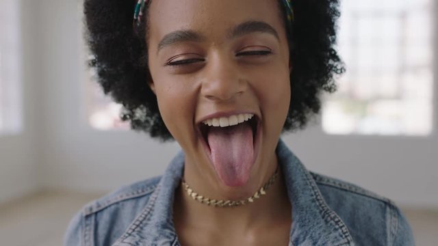 close up portrait of cute african american woman making faces looking at camera cheerful positive black female 