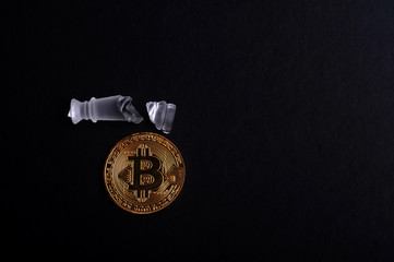 A piece of broken chess with bit-coin. Finance and business conceptual.