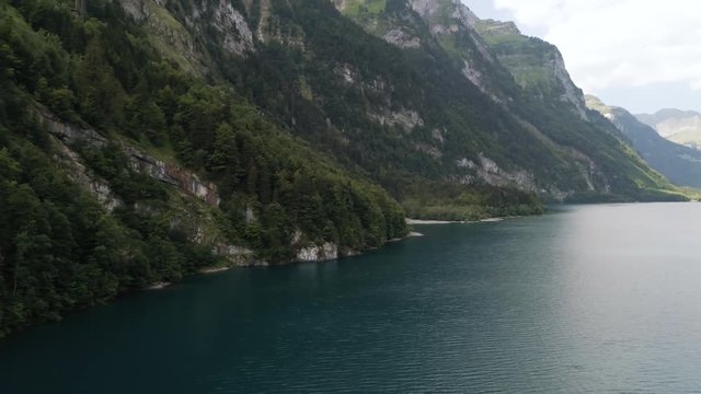 aerial view of blue mountain lake in swiss alps, klontalersee switzerland