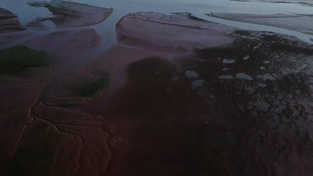 PANNING DOWN AERIAL VIDEO overlooking the low tide estuary at Lympstone in Devon