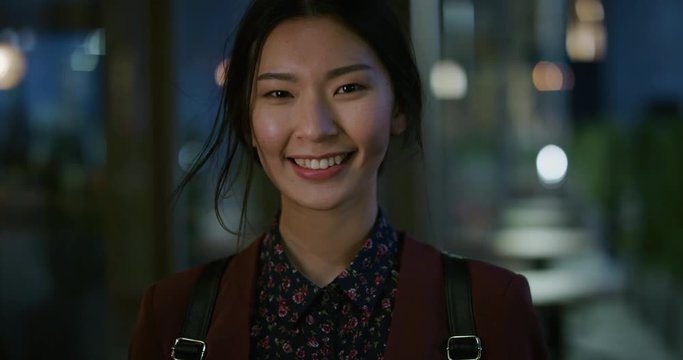 portrait happy young asian business woman student smiling enjoying professional lifestyle beautiful independent female in late urban evening slow motion