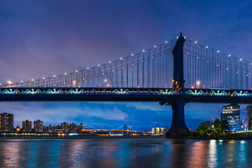 Manhattan Bridge in New York City at night over East River after sunset night view on Main Street Park