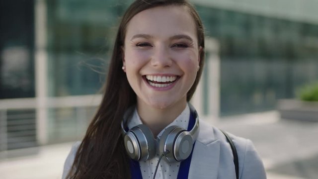 portrait of beautiful young lively woman smiling at campus intern laughing office corporate outdoors 