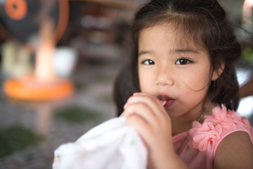 A young girl eating ice cream delicously