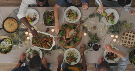 young multi ethnic friends enjoying thanksgiving lunch together making toast bonding over delicious homemade meal top view