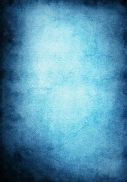 A blue and cyan grunge background with heavy paper textures and a glowing center.  Image has crack patterns and significant paper grain.