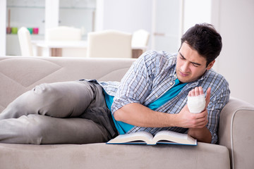 Fototapeta premium Young student man with injury at home