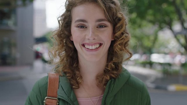 portrait of beautiful young elegant woman redhead on city street smiling cheerful optimistic enjoying happy urban lifestyle