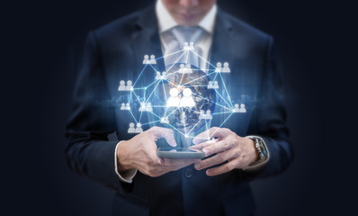 Social media and business network communication technology. Businessman using mobile phone and...