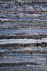 Close-up of woven fabric strips.  Textured background.