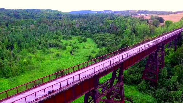 High walk-able trail bridge over large scenic landscape