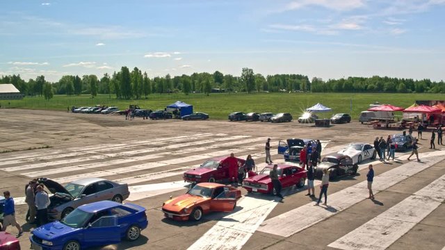 Aerial shot of cars lined up for inspection before the races