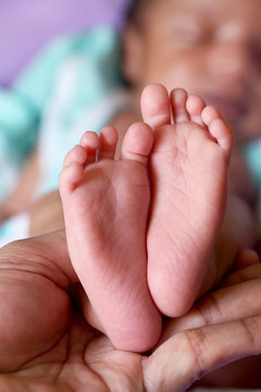 Close up of tiny feet of newborn baby