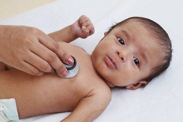 Doctor examine newborn baby with stethoscope - 215450030