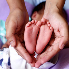 Close up of tiny feet of newborn baby