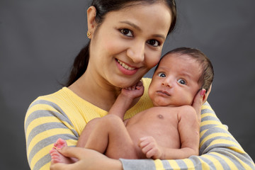 Newborn baby on hands mother 
