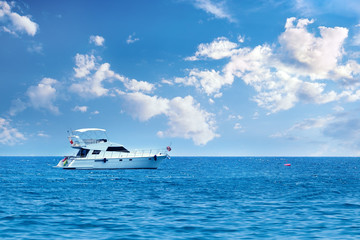Large private motor yacht out on sea on blue sky background.Vacation holiday concept.