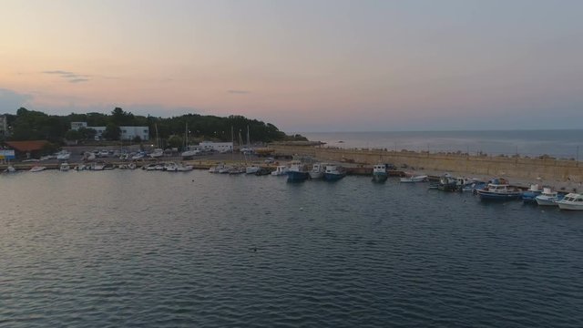 Fisherman Boats and lighthouse Aerial Low fly at Sunset ,in Carevo,Bulgaria