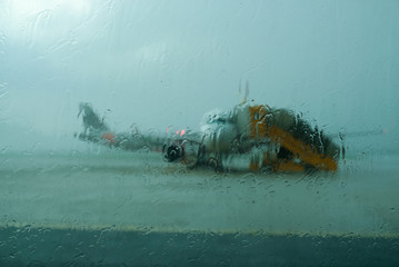 Raining on window with blur airplane background