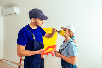 Couple ainting apartment with yellow color