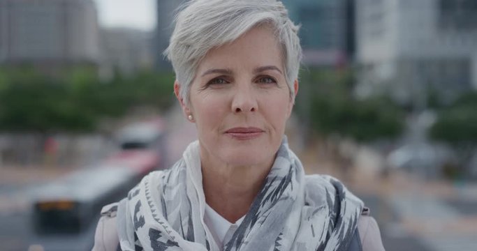 portrait beautiful senior woman turns head looking confident middle aged female enjoying successful urban lifestyle in city slow motion aging beauty