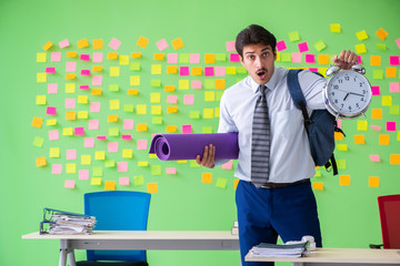 Sportive man in the office with many conflicting priorities in t